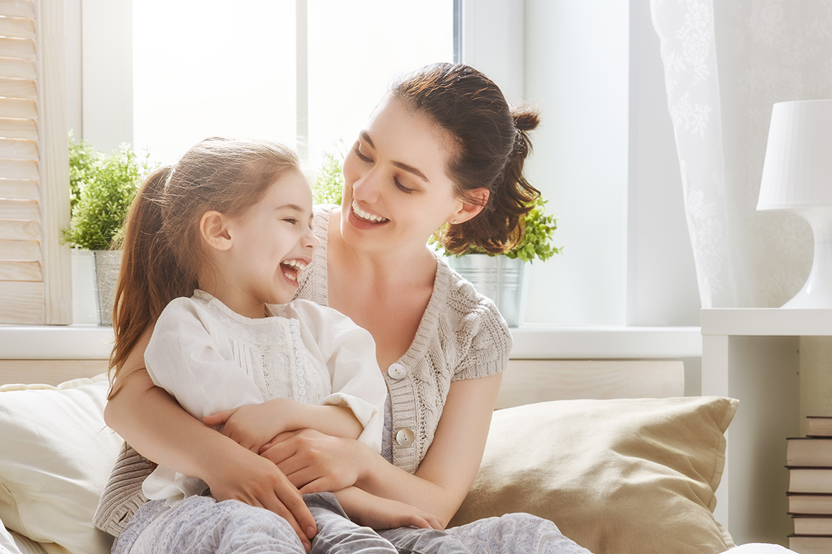 mother-hugging-child-happily-on-couch