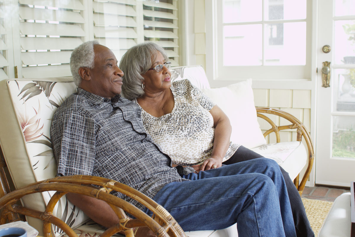 old black couple sitting on their porch