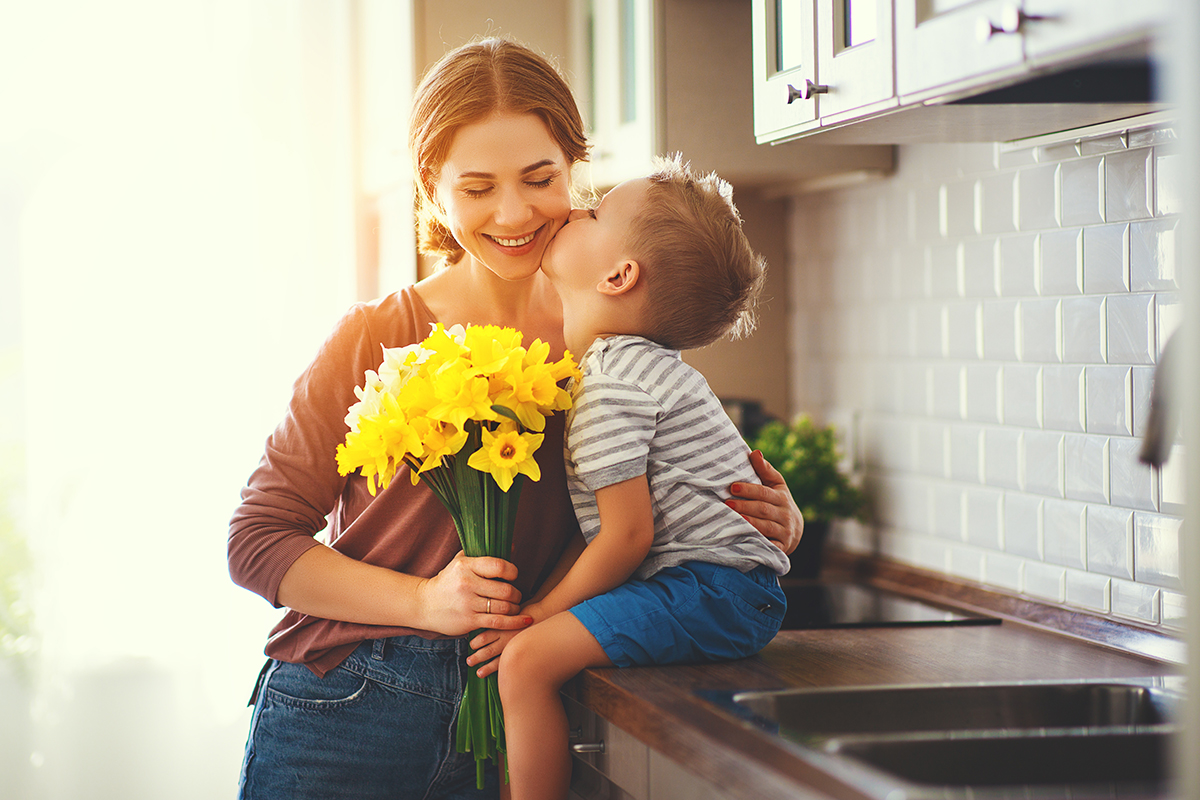 son-kissing-mom-in-kitchen